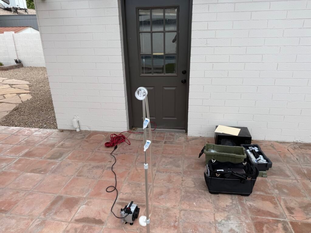 Professional Mold Testing Phoenix AZ air sampling equipment set up outside a residential property